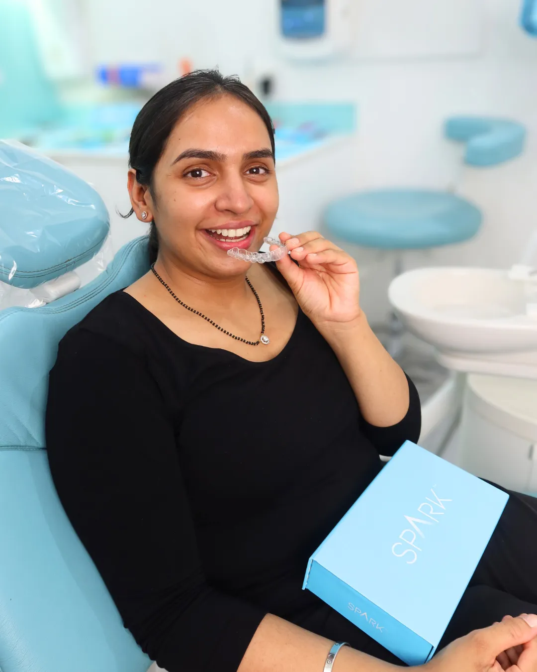 A patient at West Ryde placing a clear aligner